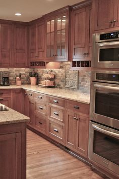 a kitchen with wooden cabinets and stainless steel appliances