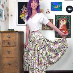 "Vintage Floral Print Skirt by Vanity, Midi Length Peasant Skirt in Pink and Purple Flower Print, Size M. Gorgeous flower print midi skirt from the 70s, possibly early 80s. It is a full circle skirt with a fitted yoke at the waist and hip. The high waist has a cross-over or faux wrap look, and the voluminous skirt flows out beneath the yoke. There are no pockets, but with a skirt this pretty, its a sacrifice worth making. Perfect bohemian style, of course; but this is also really pretty for a mo Cheap Vintage Spring Skirt, Cheap Multicolor Floral Print Skirt, Cheap Purple Floral Print Skirt, Vintage Floral Print Tiered Skirt, Vintage Tiered Skirt With Floral Print, Spring Vintage Skirted Bottoms, Vintage Tiered Skirt Bottoms For Spring, Spring Vintage Gathered Skirt, Vintage White Floral Print Skirt