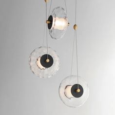 three circular glass lights hanging from the ceiling