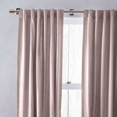 the curtain is closed and ready to be hung in front of an open window with white curtains