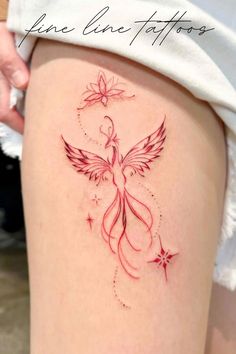 a woman's thigh with a tattoo design on the leg and an angel flying above it