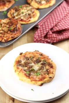 small pizzas are sitting on a white plate