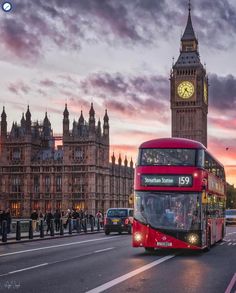 a red double decker bus driving past big ben