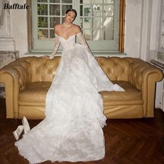 a woman in a wedding dress sitting on a couch