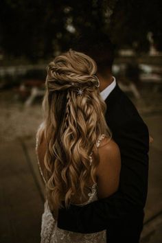 a bride and groom embracing each other on their wedding day