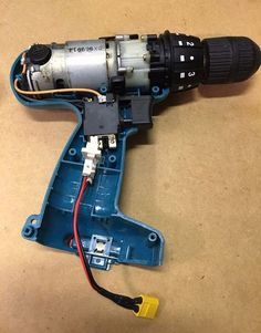 an electric drill is shown with wires attached to the body and plugged into it