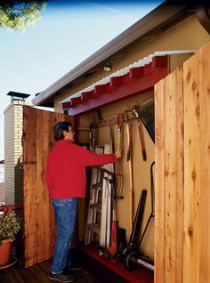 a man standing in the doorway of a storage shed