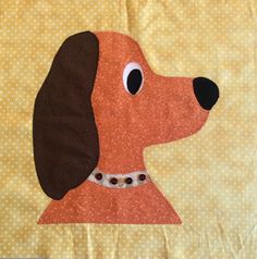 a close up of a dog's face on a quilted piece of cloth