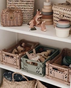 baskets and other items are on shelves in a room with wicker baskets, wooden toys, and ceramic figurines