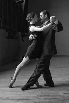 a man and woman are dancing on the dancefloor in black and white photo