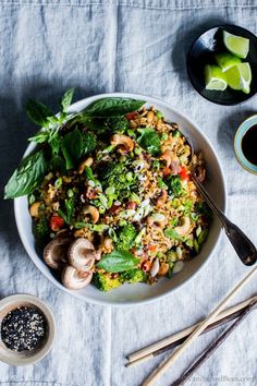 a white bowl filled with rice, broccoli and mushrooms