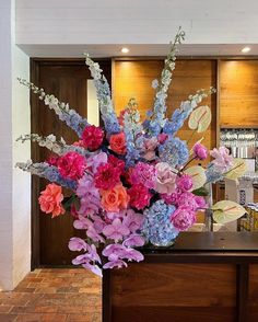 a vase filled with flowers sitting on top of a counter