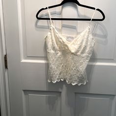 Nwt Lined Off White Lace Camisole.98% Nylon And 2% Spandex. V-Neckine With Cross Cross Bodice . Adjustable Lingerie Straps . Fitted V-neck Lace Top Camisole, White V-neck Crop Top Vest, White V-neck Vest Crop Top, Fitted V-neck Camisole For Day Out, White V-neck Lace Tank Top, White Lace V-neck Tank Top, White Lace Top V-neck Camisole, Stretch Lace Top, Blue Cami