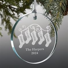 a personalized ornament hanging from a christmas tree