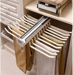 an over the door drying rack in a kitchen with towels hanging from it's sides