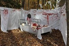 a bed in the woods with blood on it and clothes hanging up to dry out