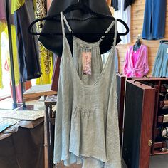 Experience pure summertime bliss with this Linen Cotton Blend distressed Hem tank top. This lightweight Italian-made top is crafted with a beautiful 50/50 blend of linen and cotton, with delicate spaghetti straps, a V neck, and a slightly distressed hem. Perfect for many occasions, this one-size-fit-all top is sure to be a hit! Spring Summer Tank Top With Tank Straps, Summer Spaghetti Strap Tank Top For Vacation, Summer Spaghetti Straps Tank Top For Vacation, Spring Tank Top With Adjustable Straps, Summer Tank Top With Adjustable Straps For Spring, Chic Cami Camisole For Beach Season, Chic Camisole For Beach Season, Chic Beach Season Camisole, Cotton Camisole With Tank Straps For Beach