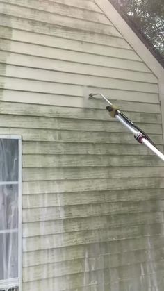 a house that has been gutted and is being cleaned with a water hose attached to the side of it