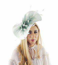 Hats By Cressida Kentucky Derby & Ascot Fascinator Hats White Sage Green Amy Kentucky Derby Fascinator Free form white base trimmed a large spray of sage green hackle and coque feathers Base measures 14 inches wide Mounted with a matching headband. If you prefer a headband to match your hair, please make a note at check out what colour headband you want. This feather fascinator is perfect for the Kentucky Derby, Royal Ascot, weddings,tea party,ladies luncheon and other formal occasions.  Designed with a free form base and an intricate spray of hackle and coque feathers, this stunning womens formal hat is the perfect wedding guest accessory. It's the ideal choice for ladies day at the races, church and garden parties. We make each hat to order just for you, we would prefer if you did not or Elegant Spring Party Headpieces, Adjustable Fascinator For Church And Carnival, Kentucky Derby Headband For Church, Elegant Wedding Fascinator For Carnival, Kentucky Derby Church Costume Headband, Elegant Mini Hats For Wedding And Carnival, Adjustable Hats For Church Carnival, Elegant Evening Hair Accessories For Summer, Elegant Evening Summer Hair Accessories