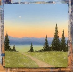 a painting of a dirt road in the middle of a field with trees and mountains