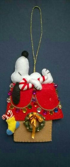 a christmas ornament with a dog and candy cane on it's back