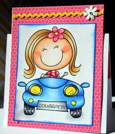 a handmade card with a girl driving a car on the front, and congratulations written in