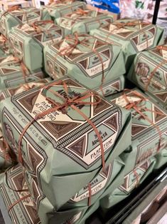 many wrapped presents sitting on top of a conveyor belt in a store or department