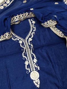 Item Overview ATHARVA Hand Embroidered Salwar Kameez w/ Embroidered Neck in Navy Blue/Hand Embroidered Dupatta Chiffon/Gota Patti/Bridal/Custom Stitch/Plazzo CH1799 Fabric: * Shirt - Chanderi Silk - Navy Blue- Embroidered Neck - 2.5 Mtrs * Dupatta: Chiffon Chinnon Dupatta- Hand Embroidered- 2.5Mts * Bottom Santoon Silk 2.5 Mts. Excusive Hand Embroidered Party Wear Punjabi Suit. 🌷CUSTOMIZATION (No Extra Charges) * Fabrics Customization: Designs Can be made in different Fabrics. *Color Customizat Hand Embroidered Dupatta, Navy Blue Embroidery, Embroidery Dupatta, Embroidered Salwar, Embroidered Dupatta, Punjabi Suit, Blue Embroidery, Blue Hand, Punjabi Suits