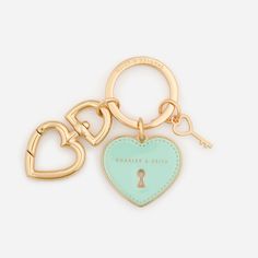 a heart shaped keychain with a lock on the front and two hearts in the back