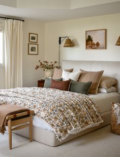 a bedroom with a large bed covered in pillows and blankets