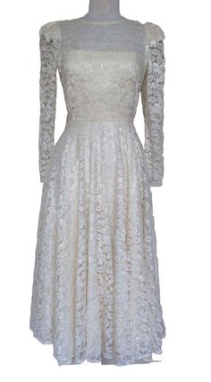 * Vintage special occasion dress from Cachet by Bari Protas * Cream polyester lace * Long sleeves * Zips in back * String belt loops (I don't have the belt) * Lined CONDITION: excellent vintage APPROXIMATE MEASUREMENTS: * shoulder to hem: 48 1/2" * bust: 33" (stretches to 34") * waist: 25" (stretches to 26") * hip: full * sleeve length: 23 3/4" Please visit our shop at: https://mezcalandleather.etsy.com At Mezcal + Leather, we spend many hours a week poring over racks and racks of less than stellar pieces looking for just the right items for you. We search the deepest, darkest crevices of vintage and consignment shops, thrift stores, estate sales and the closets of friends to find those things that take our breath away. We hope they take yours away too. If you are looking for something tha Vintage Lace Dress, Lace Dress Vintage, Special Occasion Dress, Consignment Shops, Lace Midi, Thrift Stores, Cream Lace, Estate Sales, Bari