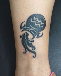 a tattoo on the foot of a person with an octopus design on it's ankle