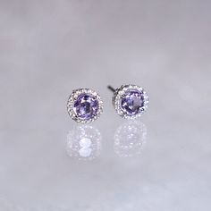 "These stylish earrings have a stunning bright color and the Amethyst is surrounded by a halo of shimmering diamonds. Perfect as a gift for yourself, your girlfriend or wife, or your mother. Features * Made to Order. * Metal: 925 Sterling Silver * Custom Color: Silver, Gold, Rose Gold * Main Stone: Amethyst, 5mm dia Round Shape, 2pcs * Side Stone: Cubic Zirconia Amethyst Ring: * Halo Ring: https://etsy.me/32kkc68 * Bypassing: https://etsy.me/32u2NIF Be sure to hit \"favorite\" on the right so it Purple Halo Jewelry As A Gift, Gift Amethyst Jewelry With Halo Design, Purple Gemstones With Halo Setting, Fine Jewelry Lavender Earrings As Gift, Purple Cubic Zirconia Round Earrings, Lavender Halo Setting Jewelry Gift, Purple Birthstone Earrings Fine Jewelry, Birthstone Engagement Rings, Halo Diamond Earrings