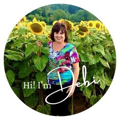 a woman standing in front of a field of sunflowers with the words hilfin'n deli written on it