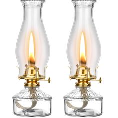 two clear glass lamps with gold trimmings on each side and one light turned on