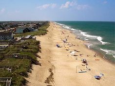 the beach is crowded with people and umbrellas