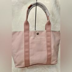 Beautiful Marc Jacobs Tote Bag Nwt Color Light Pink With Brown Leather Accent Size 18x12x7 Big Size Small Hardly Visible Marks 100% Authentic Daily Use Canvas Shoulder Bag With Branded Hardware, Pink Shoulder Bag With Dust Bag For Travel, Canvas Bags With Branded Hardware For Everyday Use, Pink Bag With Top Carry Handle For Errands, Pink Canvas Tote Bag For Errands, Pink Tote Canvas Bag For Errands, Pink Top Handle Bag For Errands, Rectangular Canvas Bag With Branded Hardware, Pink Double Handle Canvas Bag For Errands