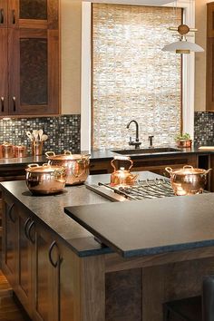 a kitchen counter with pots and pans on it