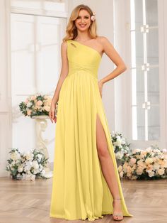 a woman in a yellow dress posing for the camera with her legs slited up