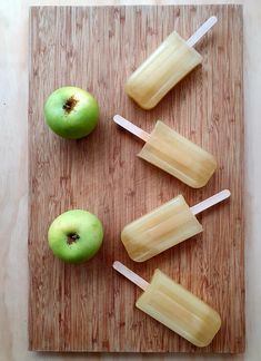 apples and popsicles on a wooden cutting board