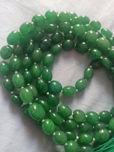 108 Beads AAA 968 Carat Emerald Dyed Japa Mala Prayer Green Color Oval Beads Japa Mala Guru bead Necklace // Long Tassel Necklace// Meditation japa mala // Guru bead// Necklace Yoga Beads Stone - Emerald Dyed Shape - Oval Size - Approx - 10x12mm Colour - Green It is known as the 'love stone' as the message it emits is the strong vibration of unconditional love, joy, warmth and healing. As quartz crystals are profound amplifiers of energy, it may help to kindle happiness, love, romantic feelings Green Hand-strung Mala With Round Beads, Green Hand-strung Mala, Handmade Oval Green Beaded Necklace, Spiritual Beaded Necklace With Faceted Oval Beads, Spiritual Beaded Necklaces With Faceted Oval Beads, Green Beaded Necklace With Large Oval Beads, Green Gemstone Beaded Bracelets With Oval Beads, Hand-strung Green Oval Beads, Green Gemstone Beads Mala