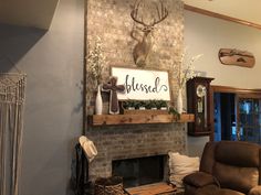 a living room filled with furniture and a fire place covered in a deer head mounted on the wall