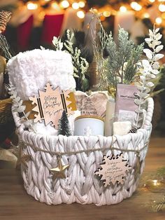 a white basket filled with christmas items on top of a table