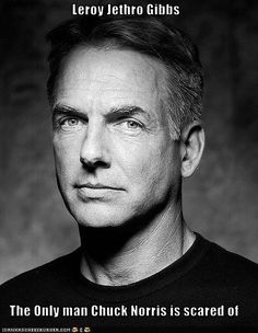 a black and white photo of a man in a t - shirt looking at the camera