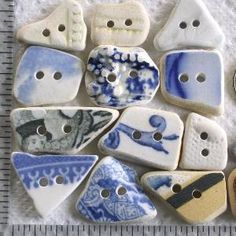 several blue and white ceramic buttons sitting next to each other