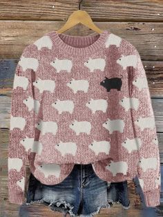 a pink and white sweater with sheep on it