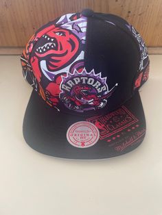 New and officially licensed coo looking Raptors SnapBack . Top quality Casual Snapback Hats For Fan Events, Black Retro Hat For Sports Events, Casual Cap For Fan Events, Adjustable Snapback Visor Hat For Fans, Multicolor Snapback Hats For Sports Events, Adjustable Throwback Hat For Streetwear, Adjustable Visor Snapback Hat For Fans, Throwback Adjustable Hats For Streetwear, Retro Curved Brim Hat For Fan Merchandise