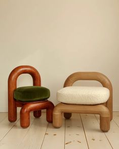 a chair and ottoman sitting on the floor in front of a wall with a white background