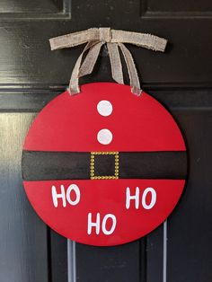 a christmas ornament hanging on a door with the words ho ho ho written on it