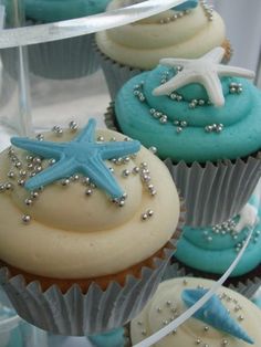 cupcakes with blue frosting and starfish decorations